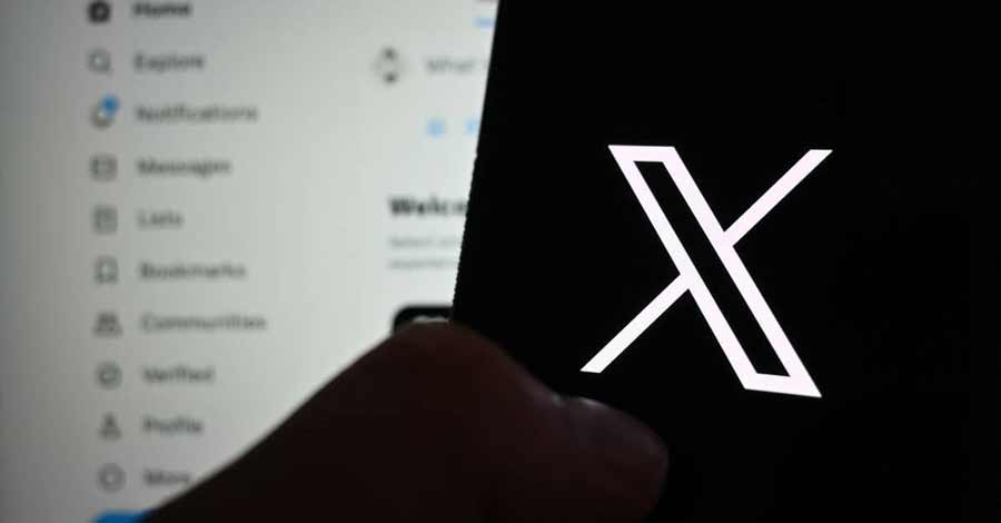 Tela de smartphone exibindo o logo branco do X (antigo Twitter) em destaque, enquanto o fundo mostra borrado a interface da plataforma com menus como Explorar, Notificações e Mensagens.